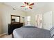 Bedroom with a large bed, dark wood dresser, and views into the hallway and bathroom at 317 Vista Lake Dr, Suwanee, GA 30024
