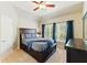 Inviting bedroom with a dark wood bed frame, tray ceiling, and ample natural light at 317 Vista Lake Dr, Suwanee, GA 30024