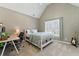 Bright bedroom featuring neutral walls, large window, and workspace with desk and chair at 317 Vista Lake Dr, Suwanee, GA 30024