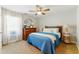 Bedroom features a bed, dresser with mirror, neutral walls, and a ceiling fan at 317 Vista Lake Dr, Suwanee, GA 30024
