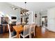 Dining room view showcasing open layout into living room with fireplace and view of the second-floor balcony at 317 Vista Lake Dr, Suwanee, GA 30024