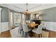 Elegant dining room with a classic chandelier, neutral decor, and ample natural light at 317 Vista Lake Dr, Suwanee, GA 30024