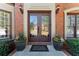 Close-up of the front door showcasing elegant details and decorative potted plants at 317 Vista Lake Dr, Suwanee, GA 30024