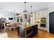 Bright kitchen with granite island, stainless steel appliances and open floor plan to living room at 317 Vista Lake Dr, Suwanee, GA 30024