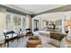 Bright living room featuring large windows, stylish seating, and open floor plan at 317 Vista Lake Dr, Suwanee, GA 30024