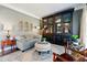 Cozy living room with a stylish sofa, built-in bookshelf, and inviting ambiance at 317 Vista Lake Dr, Suwanee, GA 30024