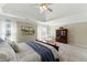 Large main bedroom with tray ceiling, large windows, and a classic wood dresser at 317 Vista Lake Dr, Suwanee, GA 30024
