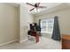 Bright office with a desk, ceiling fan, and a large window at 317 Vista Lake Dr, Suwanee, GA 30024