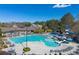 Community pool with a slide and a sundeck surrounded by lounge chairs, umbrellas and tables at 317 Vista Lake Dr, Suwanee, GA 30024