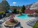 Inviting pool area with lounge chairs and umbrellas, offering a perfect spot for relaxation and recreation at 317 Vista Lake Dr, Suwanee, GA 30024
