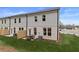 Two-story home with gray siding and brick foundation, backyard and table with chairs at 425 Brooch Way, Stockbridge, GA 30281