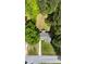 Bird's-eye view of a home's roof, driveway, and yard surrounded by mature trees and a street at 530 Bell Se Rd, Conyers, GA 30094