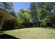 Spacious grassy backyard surrounded by mature trees at 530 Bell Se Rd, Conyers, GA 30094