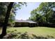 Single-story home with a well-manicured lawn surrounded by mature trees at 530 Bell Se Rd, Conyers, GA 30094