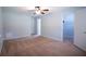 Neutral toned bedroom featuring a ceiling fan, walk in closet and wall to wall carpeting at 530 Bell Se Rd, Conyers, GA 30094