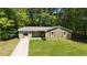 Charming green home with red door and shutters, stone facade, and a well-manicured lawn at 530 Bell Se Rd, Conyers, GA 30094