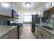 Modern kitchen with stainless steel appliances, granite countertops, and stylish tile backsplash at 530 Bell Se Rd, Conyers, GA 30094