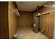 Storage room featuring wood paneling, shelving and hot water tank at 530 Bell Se Rd, Conyers, GA 30094