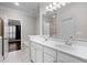 Bathroom featuring double sinks, white cabinetry, tile floors, and a large mirror, offering ample space at 1123 Providence Pl, Decatur, GA 30033