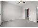 Carpeted bedroom with a ceiling fan and bathroom access at 1123 Providence Pl, Decatur, GA 30033