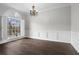 Bright dining room features large window, elegant chandelier, and classic wood floors at 1123 Providence Pl, Decatur, GA 30033