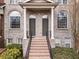 Close-up of brick townhome entrances with symmetrical design elements and lush green landscaping at 1123 Providence Pl, Decatur, GA 30033