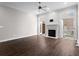 Spacious living room with dark hardwood floors, fireplace, ceiling fan, and French doors to a balcony at 1123 Providence Pl, Decatur, GA 30033