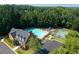 Overhead view of community amenities featuring a pool, playground, and parking lot surrounded by lush trees at 2365 Barrington Trace Sw Cir, Atlanta, GA 30331