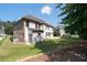 The spacious backyard features a green lawn, a concrete patio, and beautiful mature trees for added privacy at 2365 Barrington Trace Sw Cir, Atlanta, GA 30331