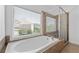 Serene bathroom featuring a large soaking tub and separate shower, perfect for relaxation with natural light at 2365 Barrington Trace Sw Cir, Atlanta, GA 30331