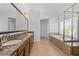 Bathroom featuring granite countertops, double sinks, tile flooring, and a luxurious soaking tub with shower at 2365 Barrington Trace Sw Cir, Atlanta, GA 30331