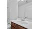 Bathroom featuring a vanity with a white countertop, a wood cabinet, and a framed mirror above the sink at 2365 Barrington Trace Sw Cir, Atlanta, GA 30331