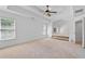 Spacious bedroom with tray ceiling and adjoining room with fireplace, showcasing open layout and natural light at 2365 Barrington Trace Sw Cir, Atlanta, GA 30331