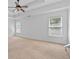 Bright bedroom with ceiling fan, white walls, and neutral carpet with natural light streaming through the window at 2365 Barrington Trace Sw Cir, Atlanta, GA 30331