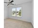 Bright bedroom with neutral carpet and a large window, creating a serene and inviting atmosphere at 2365 Barrington Trace Sw Cir, Atlanta, GA 30331