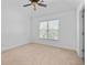 Spacious bedroom features a tray ceiling, large windows, and neutral carpet, creating a relaxing atmosphere at 2365 Barrington Trace Sw Cir, Atlanta, GA 30331