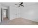 This bedroom features neutral carpet, a ceiling fan, and a closet with double doors for ample storage space at 2365 Barrington Trace Sw Cir, Atlanta, GA 30331