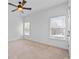 Bright bedroom with two windows and a ceiling fan offers a simple, yet comfortable design at 2365 Barrington Trace Sw Cir, Atlanta, GA 30331