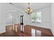 Formal dining room boasts hardwood floors, chandelier, and natural light, adjacent to an open archway at 2365 Barrington Trace Sw Cir, Atlanta, GA 30331