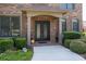 Elegant entryway with double doors and manicured bushes provide a warm, welcoming entrance at 2365 Barrington Trace Sw Cir, Atlanta, GA 30331
