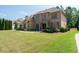 Well-maintained brick home with a spacious lawn and mature trees exudes classic elegance and charm at 2365 Barrington Trace Sw Cir, Atlanta, GA 30331