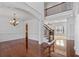 Bright and spacious foyer with hardwood floors, elegant staircase and chandelier creates a grand entrance at 2365 Barrington Trace Sw Cir, Atlanta, GA 30331