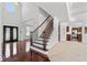 Grand foyer features soaring ceilings, hardwood floors, a staircase and an open concept design, for a modern feel at 2365 Barrington Trace Sw Cir, Atlanta, GA 30331
