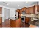 Kitchen showcasing stainless steel appliances, a central island, and warm wood cabinetry at 2365 Barrington Trace Sw Cir, Atlanta, GA 30331