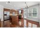 Well-lit kitchen with stainless steel appliances, central island and dark wood flooring at 2365 Barrington Trace Sw Cir, Atlanta, GA 30331