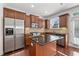 Kitchen boasting stainless steel appliances, a central island, and warm wood cabinets at 2365 Barrington Trace Sw Cir, Atlanta, GA 30331