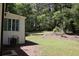 Large backyard featuring mature trees with a view of home exterior and an AC unit at 3811 Crosby Nw Dr, Atlanta, GA 30331
