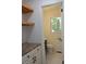 Well-lit powder room with modern vanity and floating wood shelves at 3811 Crosby Nw Dr, Atlanta, GA 30331