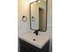 Bathroom vanity with a modern faucet, stylish mirror, and matte black fixtures at 3811 Crosby Nw Dr, Atlanta, GA 30331