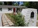 Well-maintained home featuring a brick mailbox with a concrete walkway and a blooming rose bush at 3811 Crosby Nw Dr, Atlanta, GA 30331